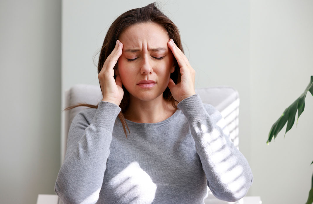 Woman using yoga to manage migraines