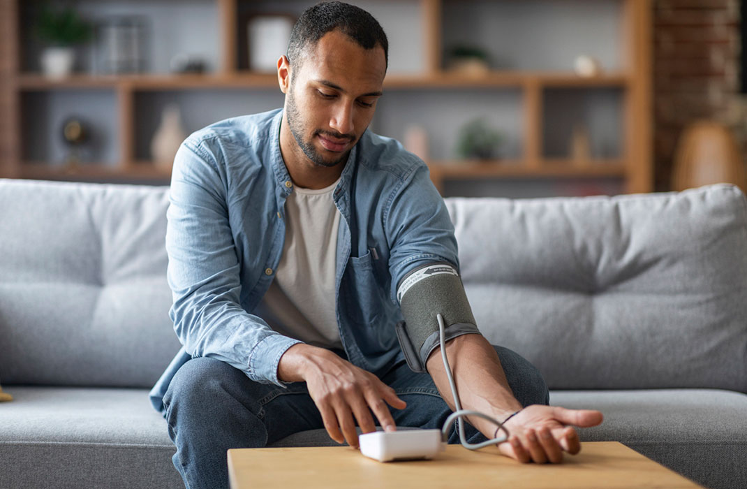 Man measures blood pressure at home. 