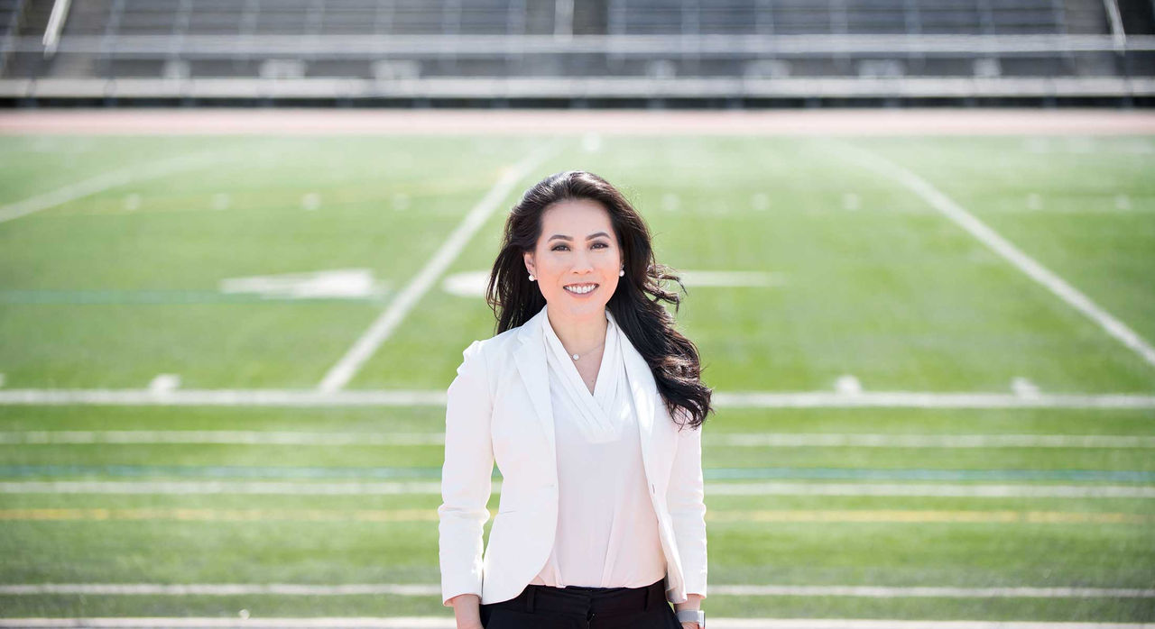 Dr. Miho Tanaka in a football stadium.