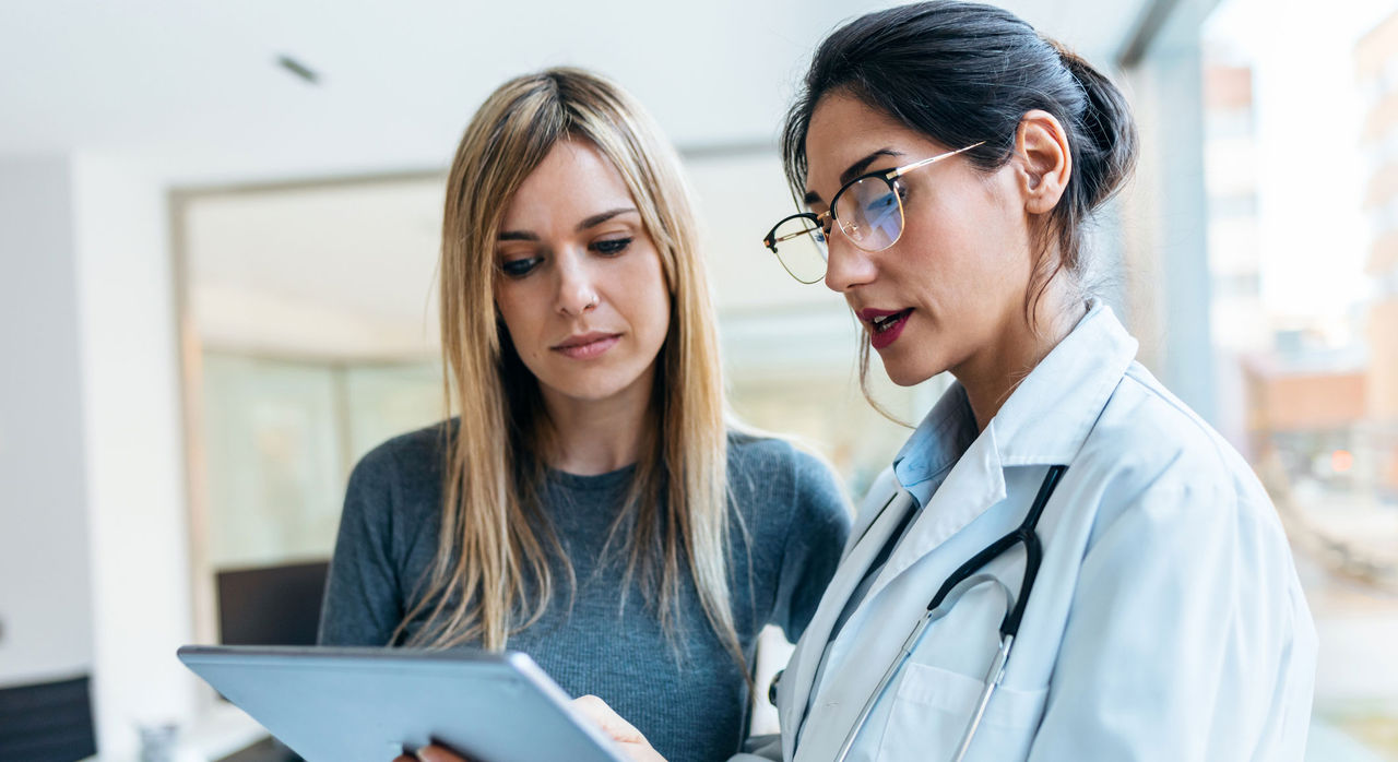 A female patient speaks with a doctor. 