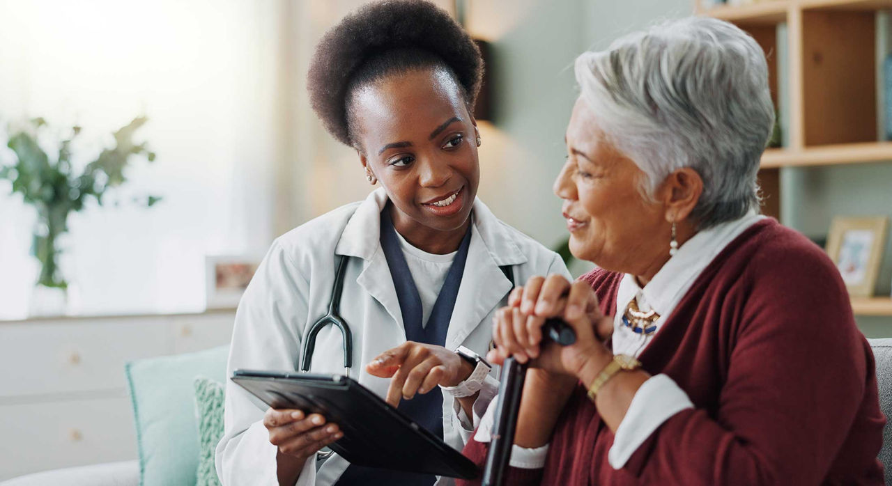A female patient speaks with her doctor. 