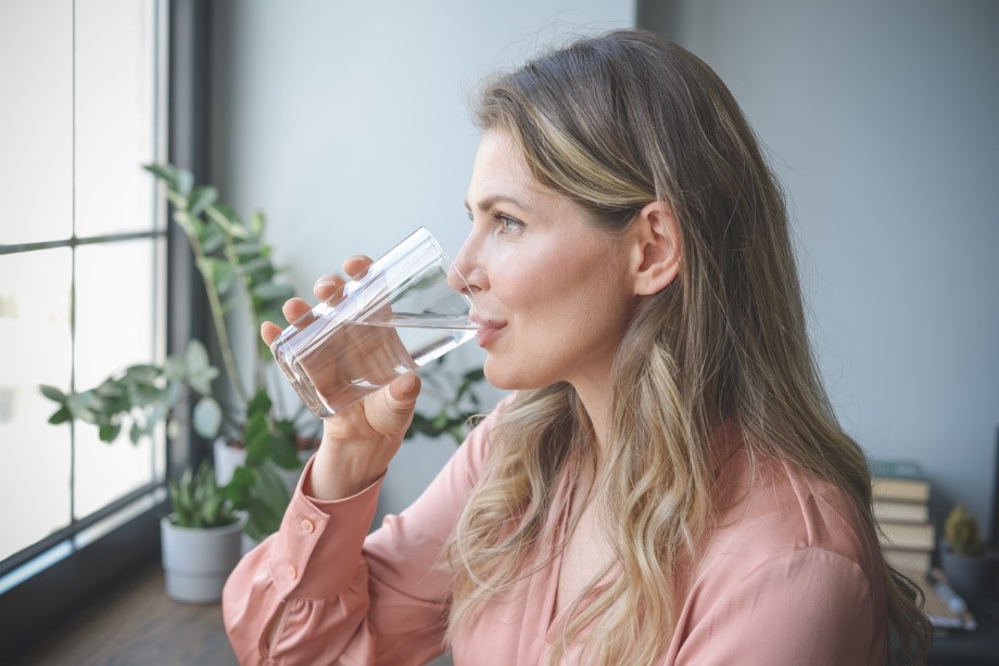 Woman drinks water to prevent UTIs