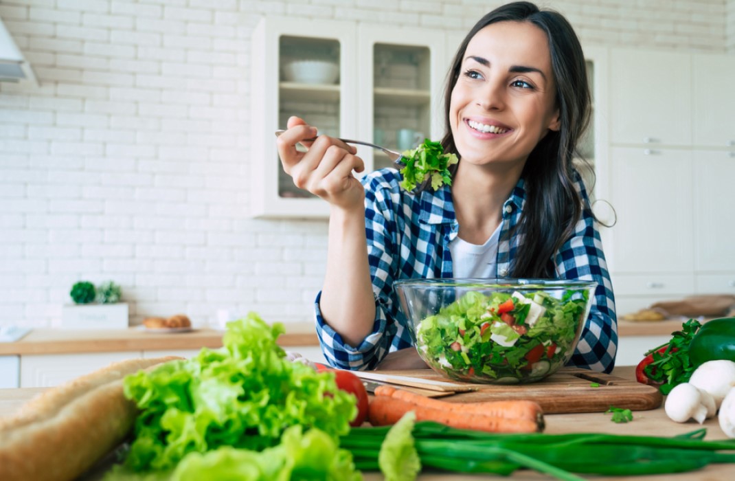 Woman eating a healthy meal with vegetables