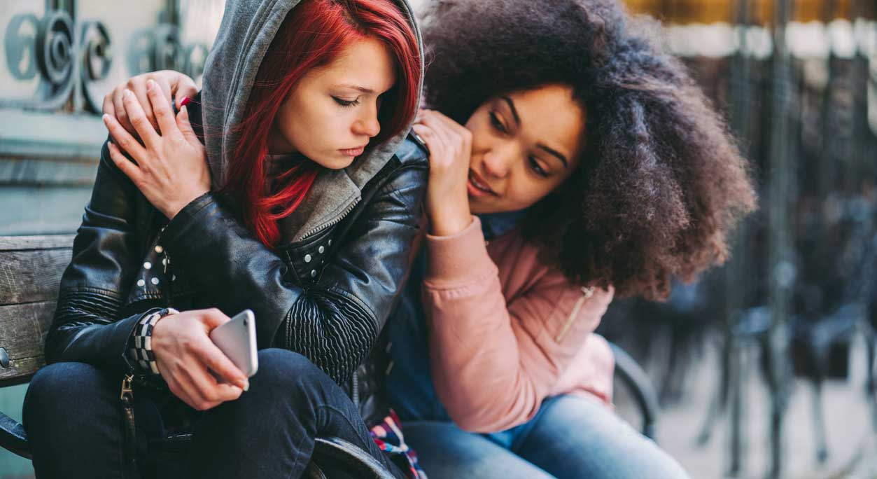 One teen girl comforts another.