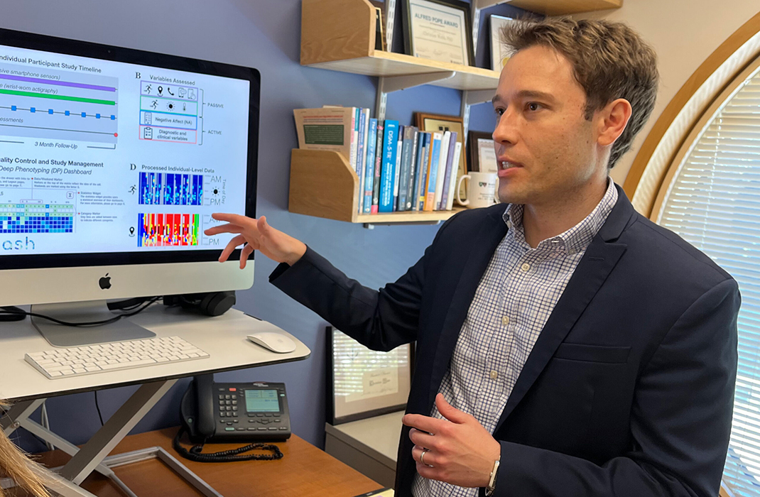 A man pointing at a computer screen