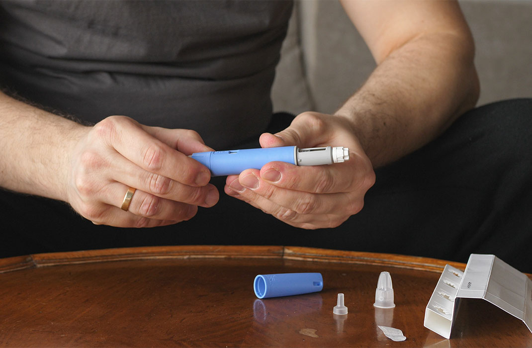 A man prepares a dose of semaglutide.