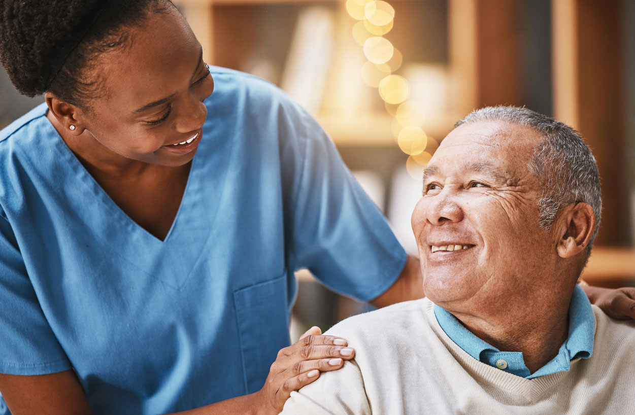 A nurse with a smiling older male patient.