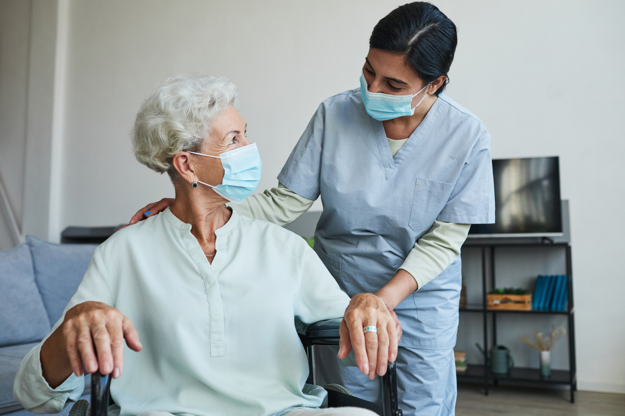 Visiting nurse speaks with patient about at-home dialysis