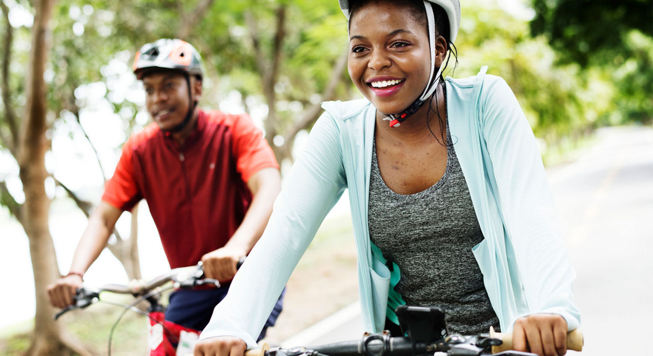 Couple riding bikes. Bike riding and other physical activity have brain health benefits.