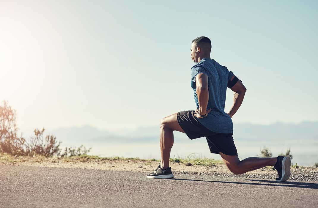 A man performing runner’s lunges.