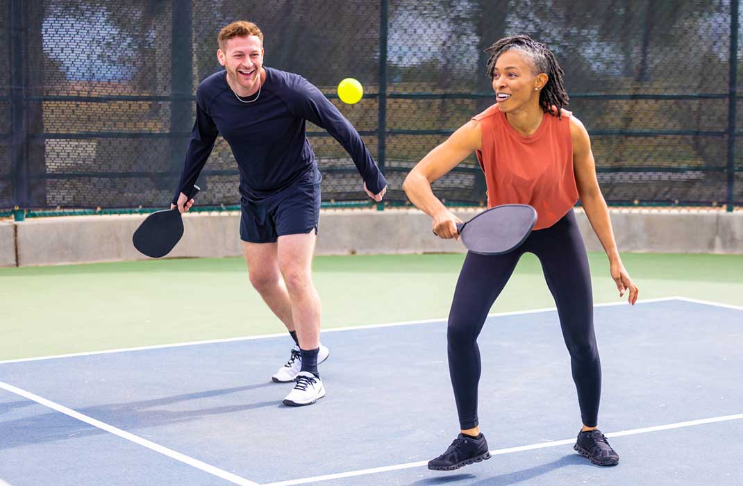 Two people playing a game of pickleball.