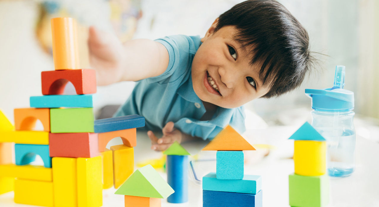 A child plays with toys inside