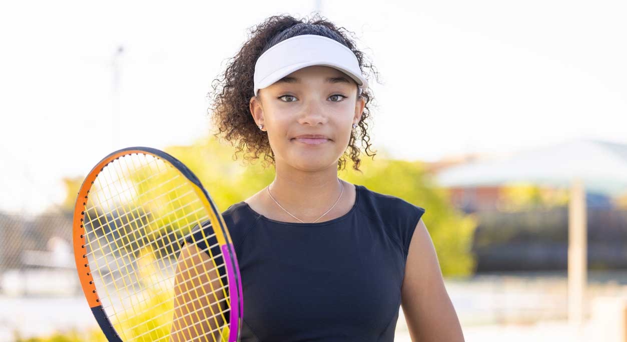 A young tennis player at the park.