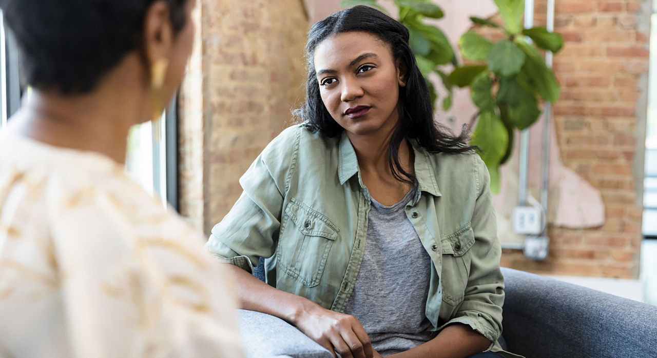 A concerned young woman talks with her counselor.