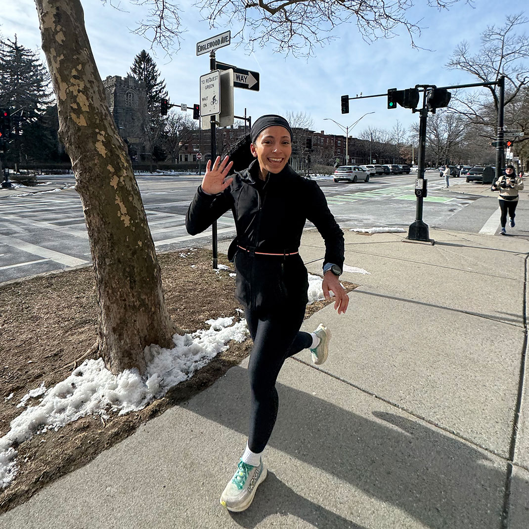 Ashley Panzone waves to the camera as she jogs.