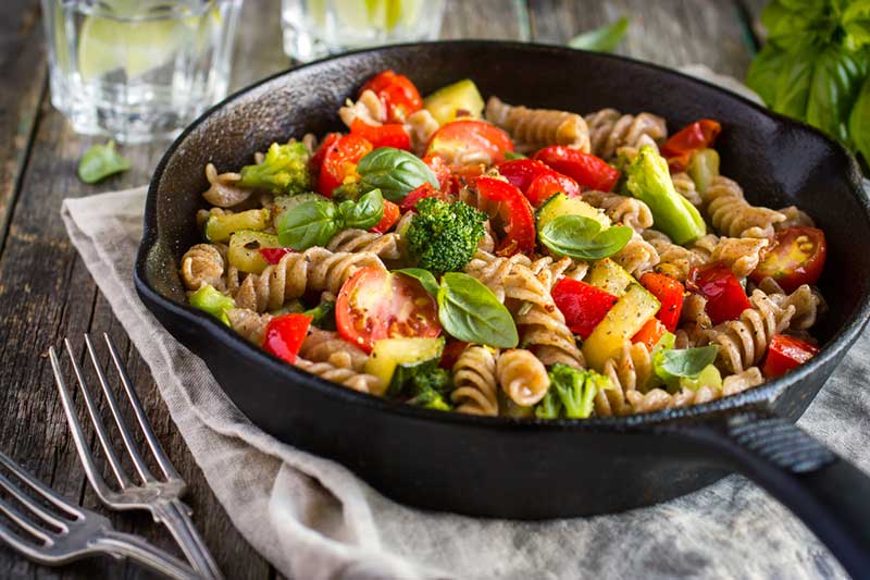 Skillet of whole wheat pasta and vegetables.
