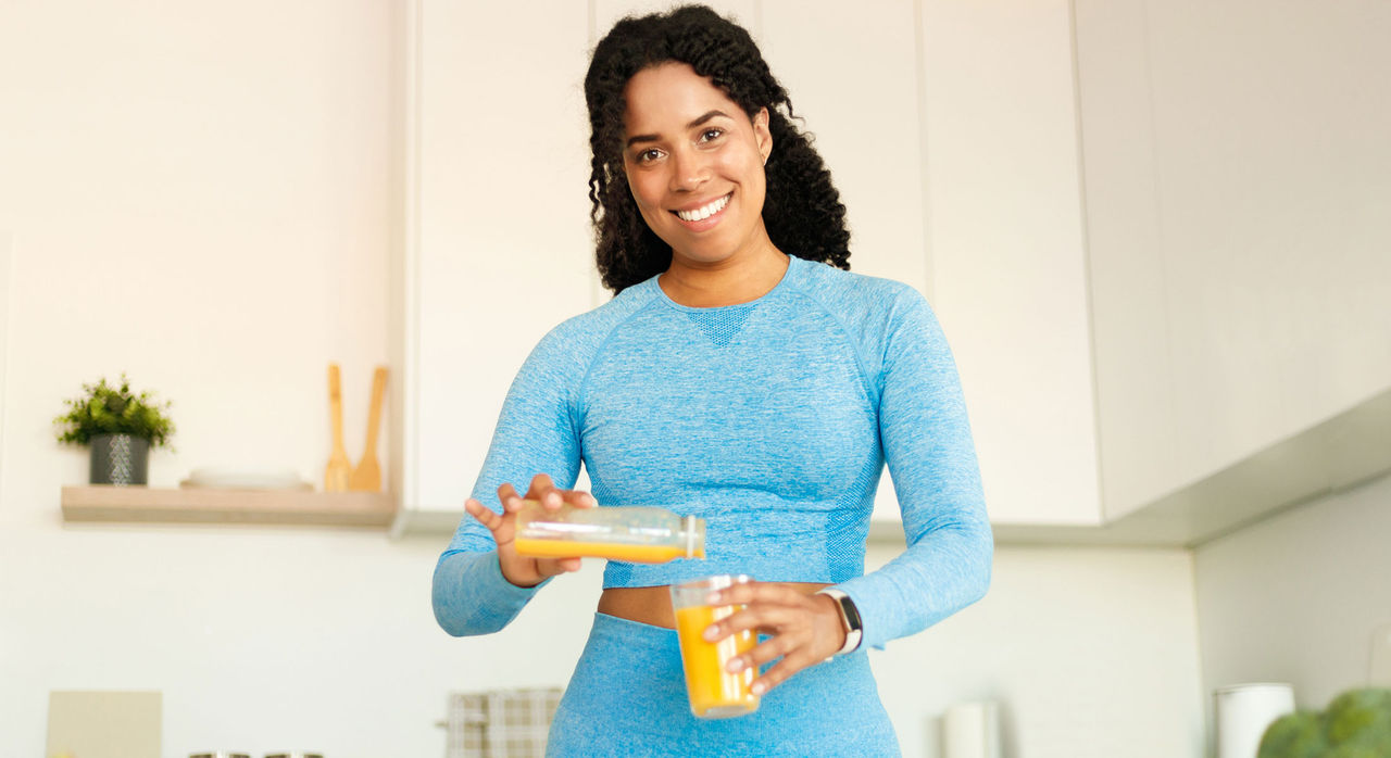 A female athlete enjoys a nutritious drink.