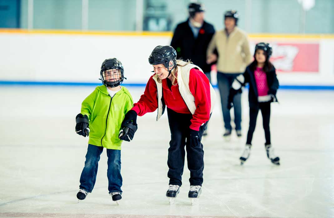 A child and woman skating indoors