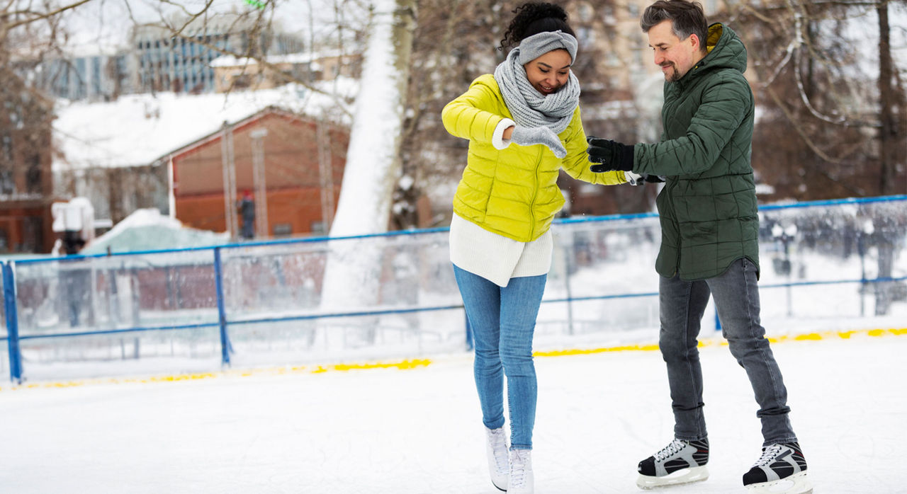 Young adult couple ice skating
