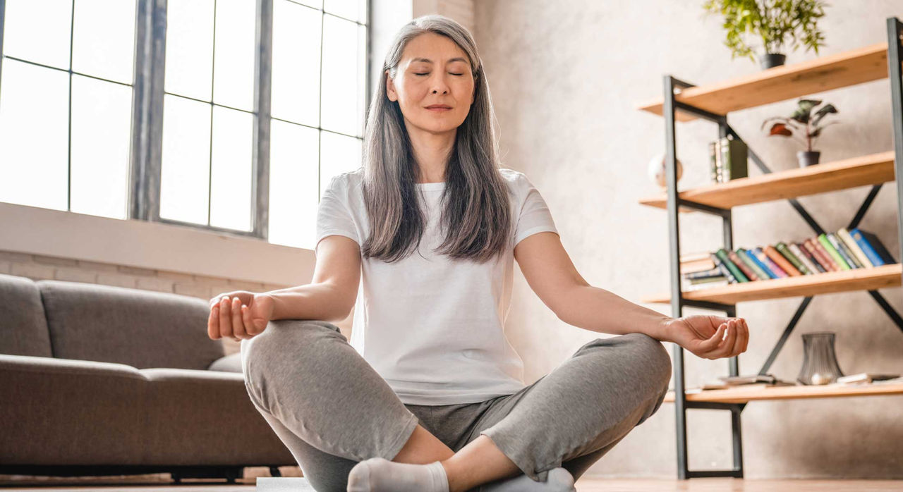 A woman with heart failure meditates to relieve stress.
