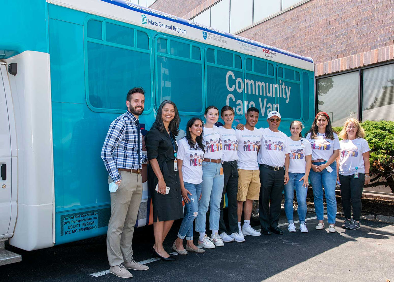 Volunteers posing in front of a Community Care Van.