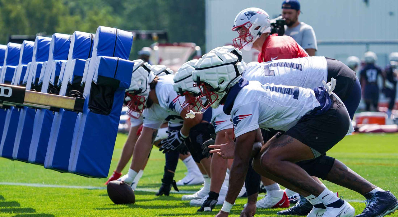 American football players practicing at training camp