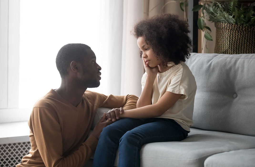 Father comforts sad daughter
