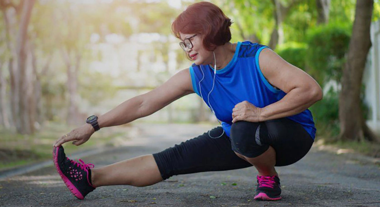 woman stretching her leg outdoors