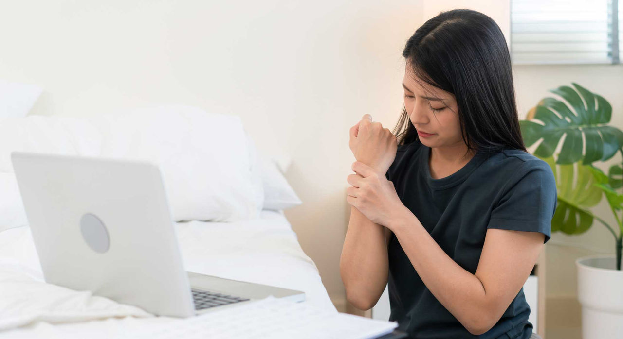 Woman with wrist pain from lupus.