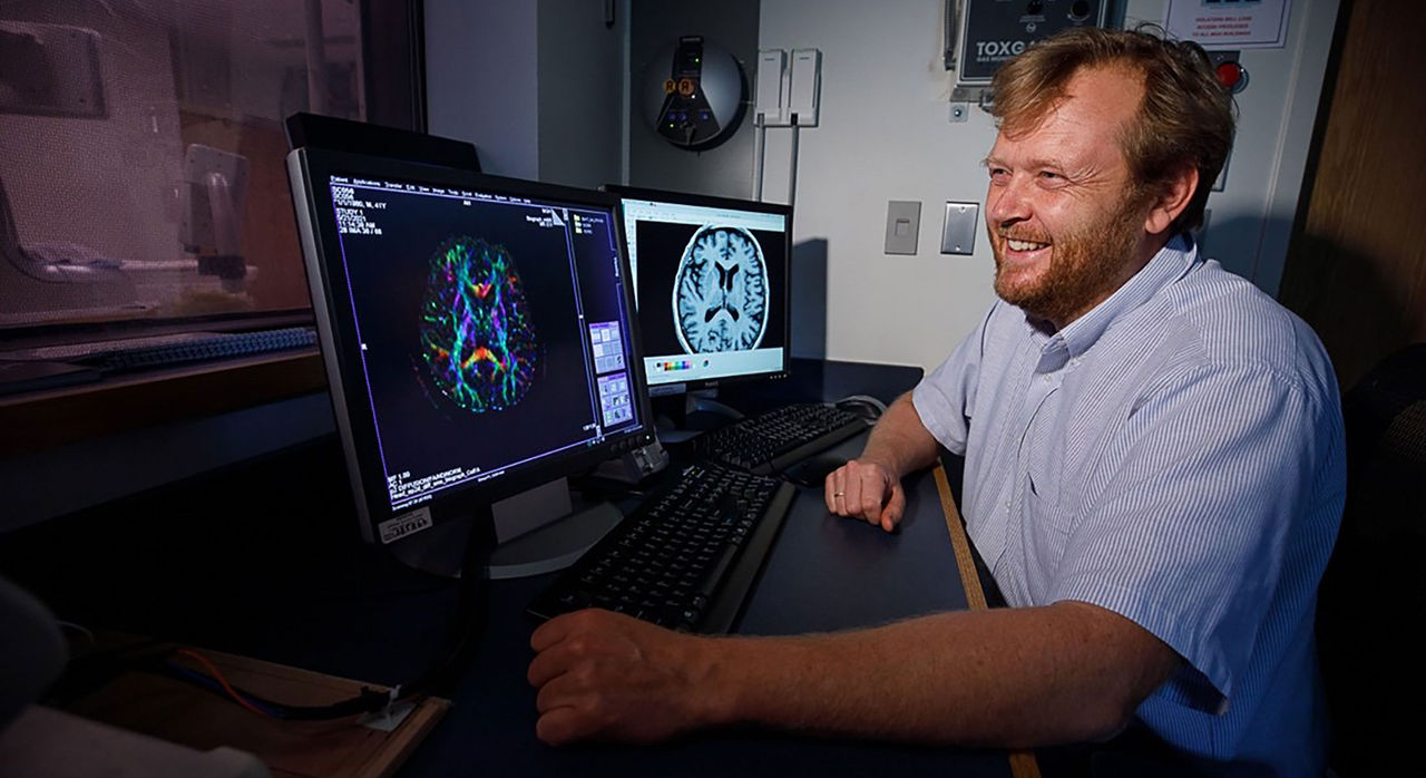 Clas Linnman looks at a brain scan to monitor the effects of Auditory Mirror Therapy