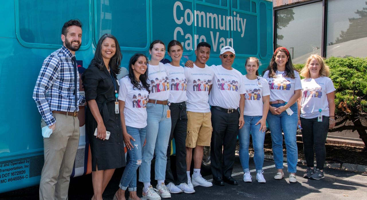 Members of the Community Care Team pose with Dr. Taveras in front of the Community Care Van.