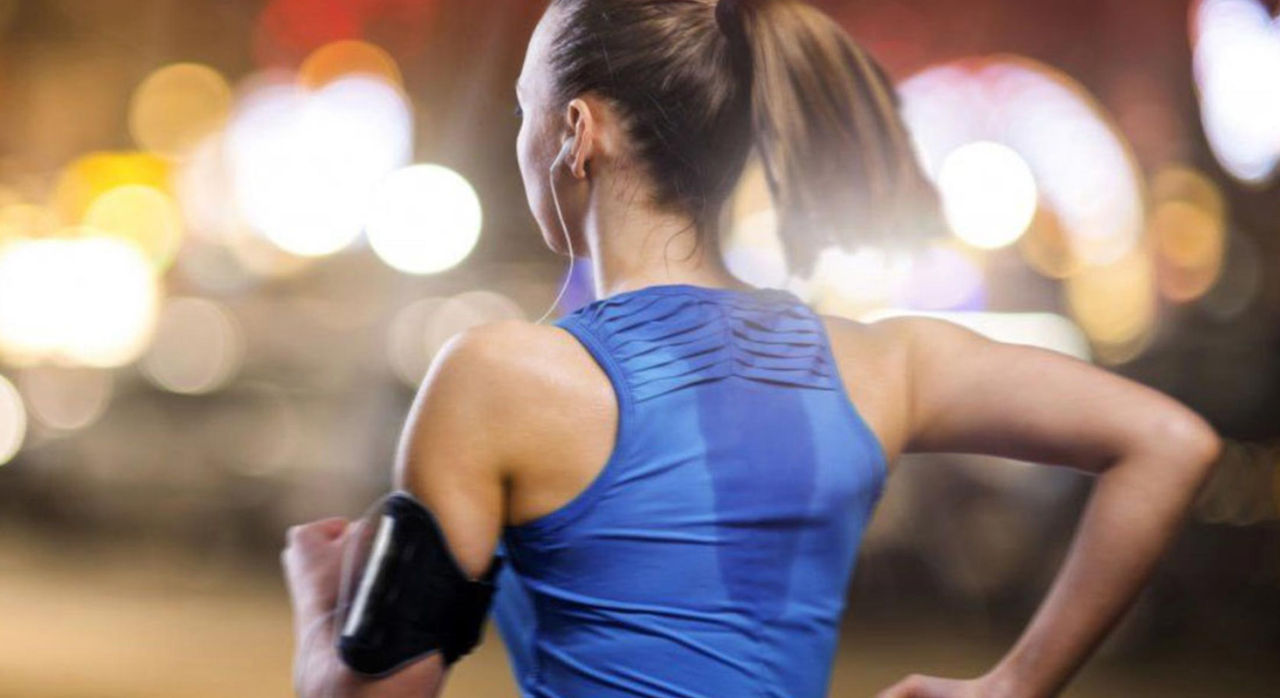 female athlete running outdoors at night