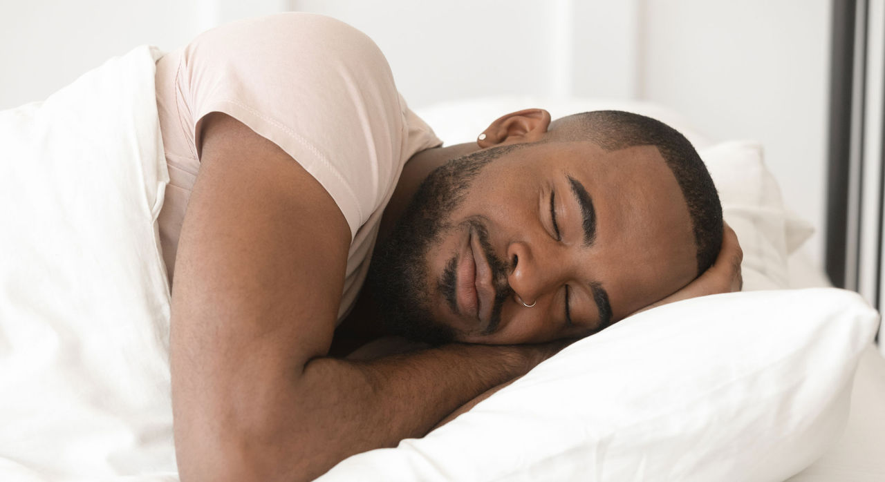 A man asleep in bed.
