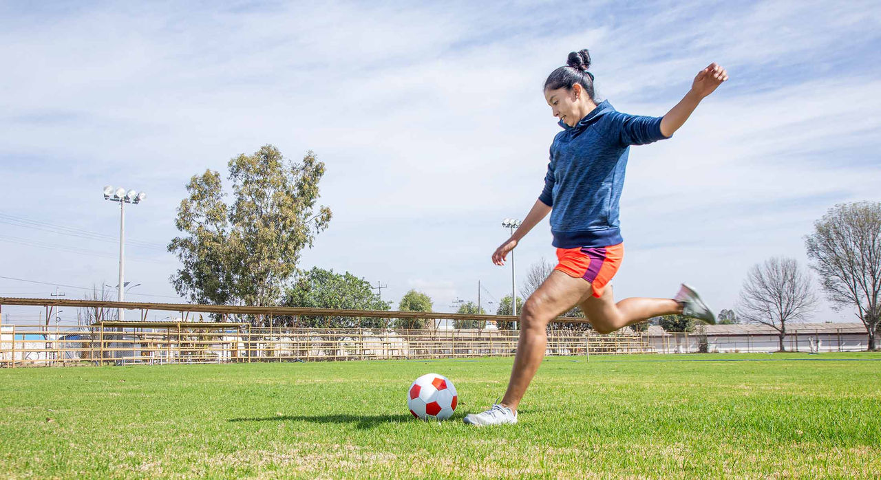 Woman kicks soccer ball