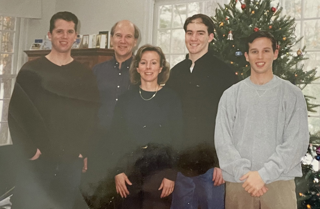 Chris Kobos standing with family on Christmas in 1998.