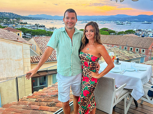 A man and woman posing for a photo together on a restaurant’s rooftop in Southern France