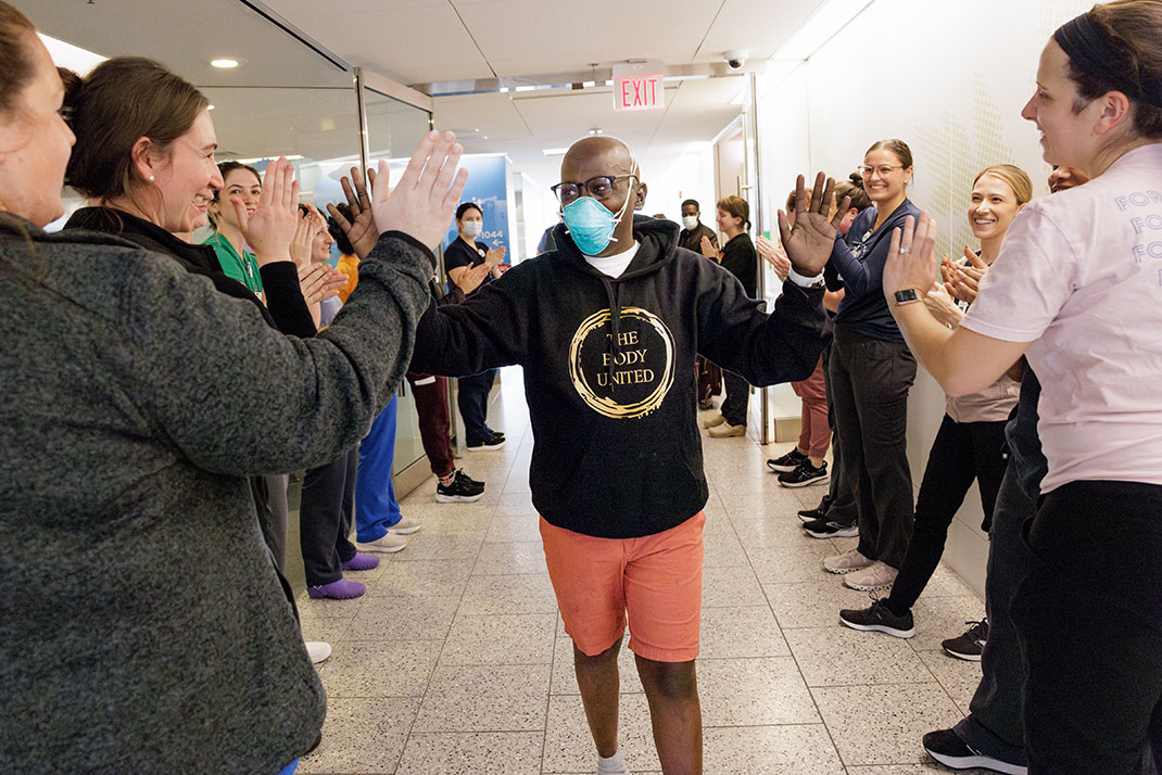 Allan high-fiving hospital staff as he leaves the hospital after treatment.