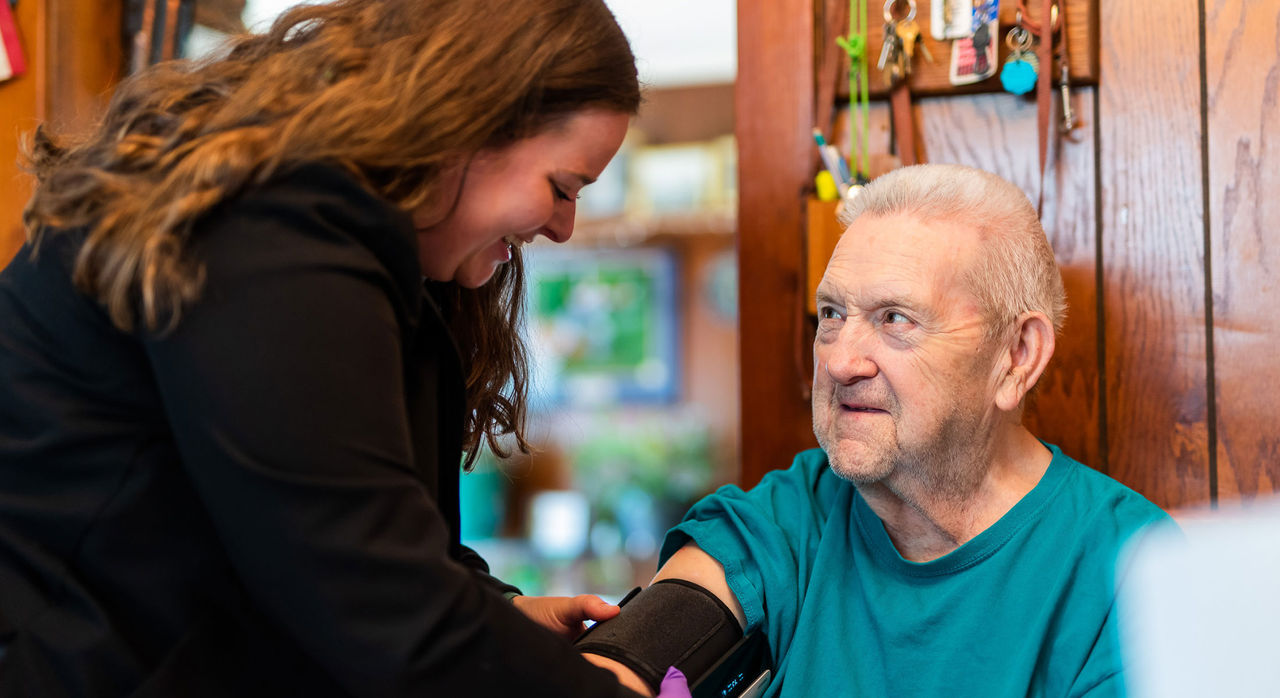 Nurse takes blood pressure of Home Hospital patient