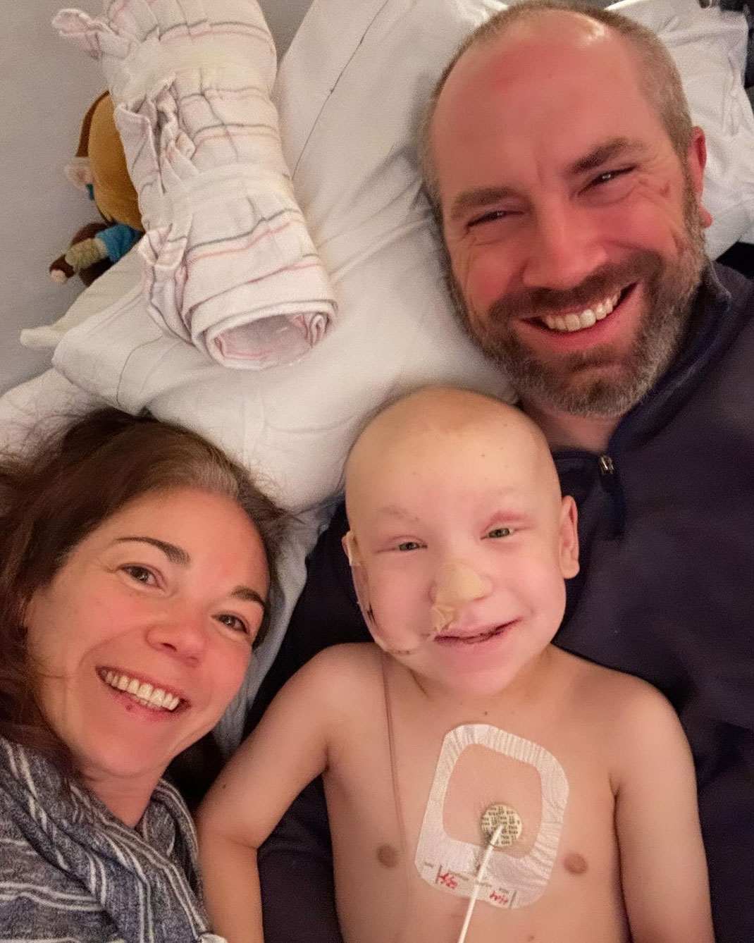 Theo with his parents during his second stem cell transplant in December 2023
