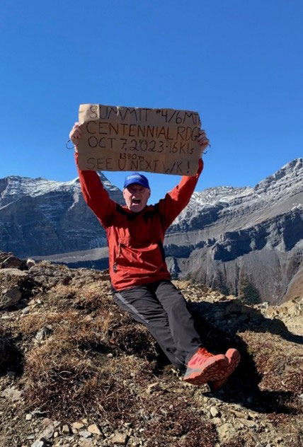 Living liver donor Lee holds a sign on a mountain