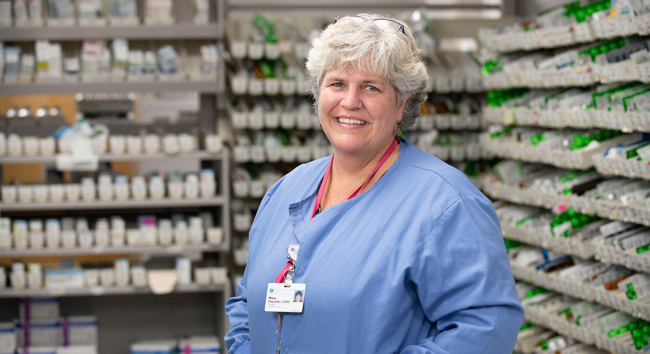 Mary Fournier in the pharmacy where she works.