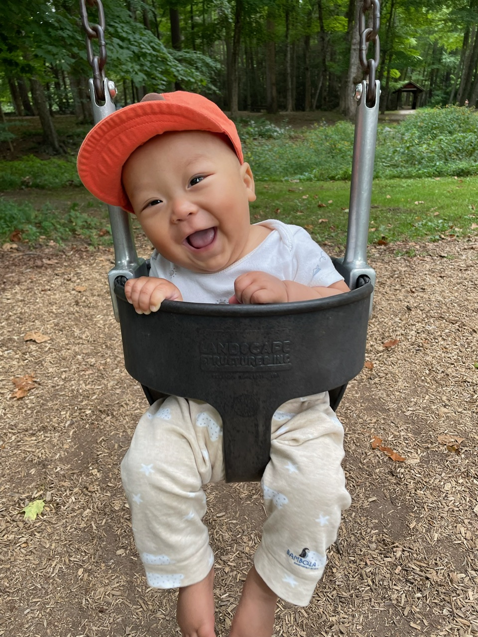 Baby Ben smiling on a swing. 