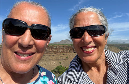 Flora (right) and her sister exploring their roots in Cape Verde, four months after Flora’s surgery in October 2022.