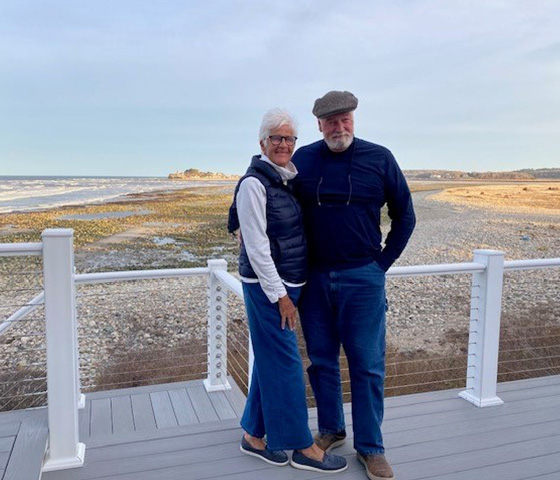 Older couple standing on coastal boardwalk