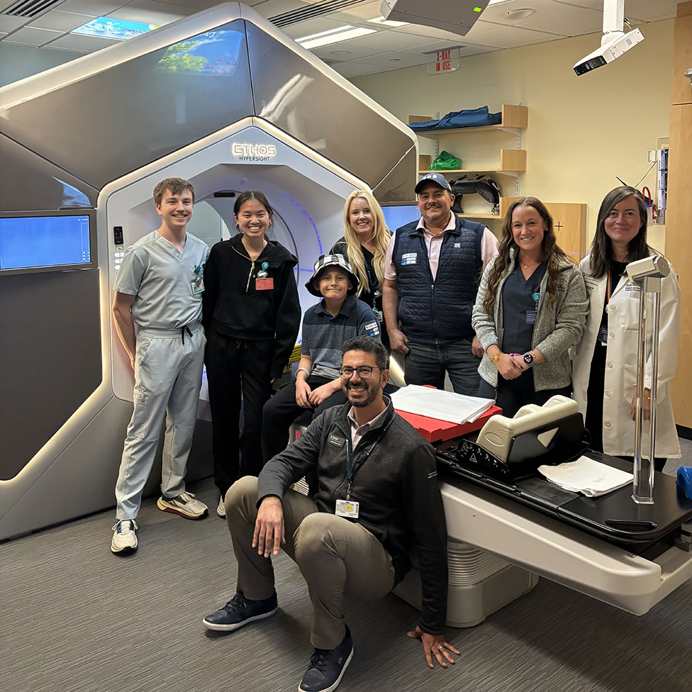 Remy and his dad with care team members from the Mass General Brigham Cancer Institute