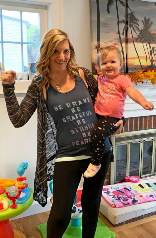 Stefania holding 18-month-old Sofia on her hip.