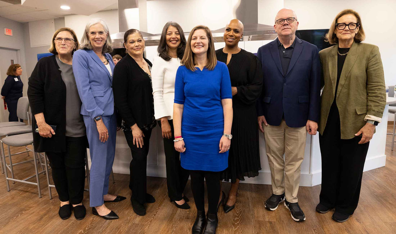 A group of eight people standing together for a photo