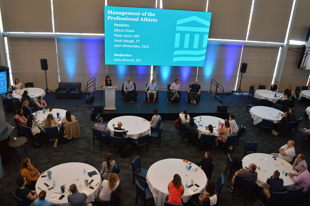 A view from the conference audience of panelists Zdeno Chara, Peter Asnis, MD, Scott Waugh, PT, and John Whitesides CSCS, with moderator Kelly McInnis, DO