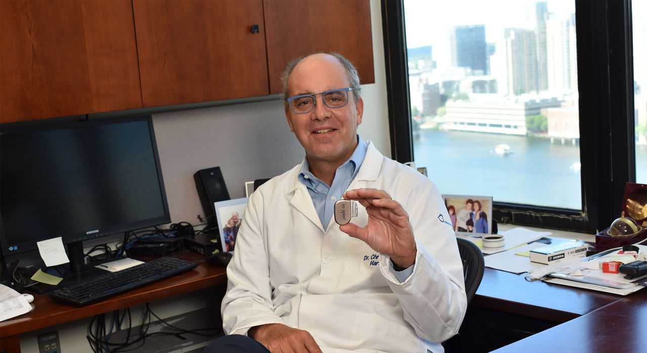 Dr. Hartnick holds up the hypoglossal nerve stimulation device he and his team developed.