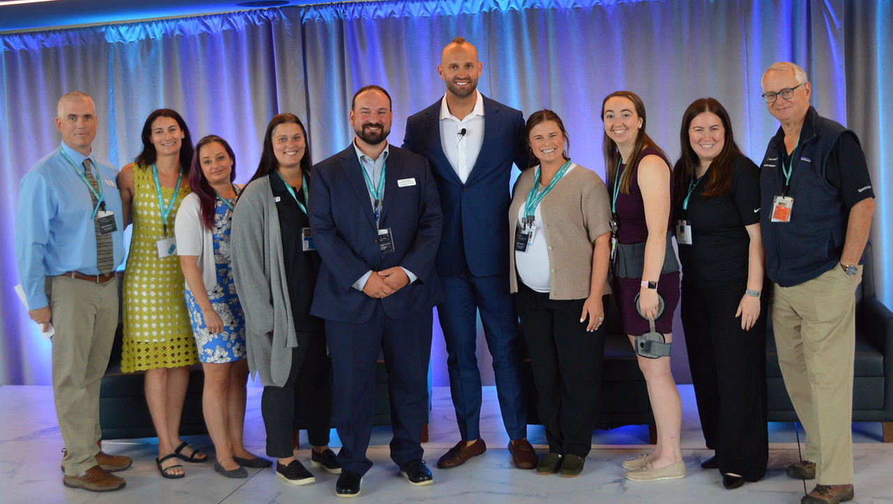 Mark Herzlich poses with Mass General Brigham Sports Medicine Athletic Training Program leadership and staff. at the 2025 Athletic Training Conference.